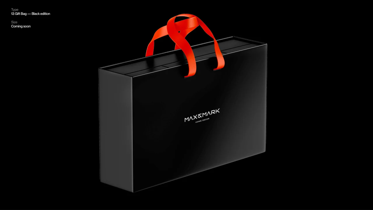 Max and Mark: A black gift bag with orange handles.